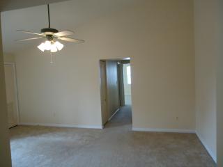 Living Room With Ceiling Fan And A Vaulted Ceiling