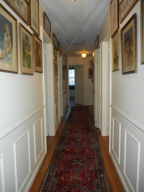 Hall With Picture Moulding And Hardwood Floors